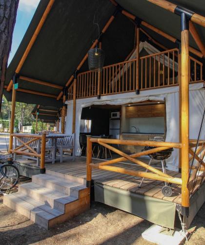 Wooden glamping tent in nature with a terrace.